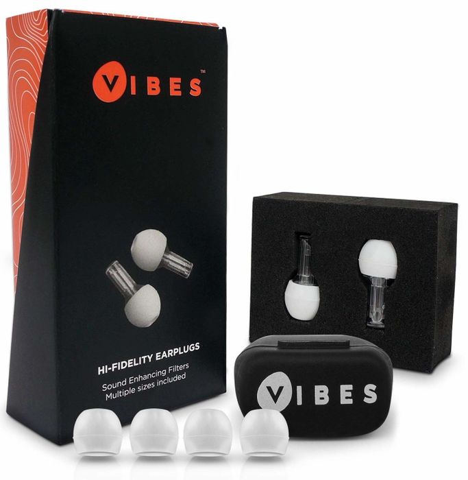 The earplugs resting next to their packaging and a compact carrying case, perfect for stashing in your bag while traveling.