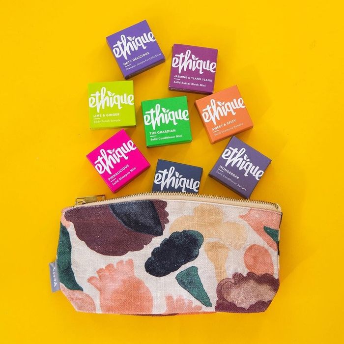 eight different Ethique shampoo bars being packed into a toiletry bag