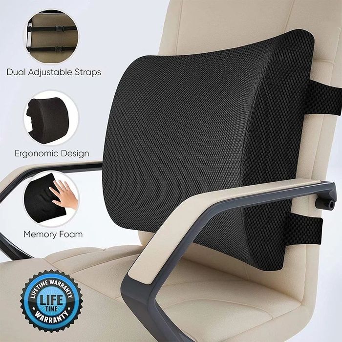 A black lumbar pillow resting on a cream-colored office chair, offering a subtle touch of comfort and support.