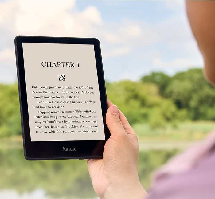 A model engrossed in reading a book on the Kindle Paperwhite