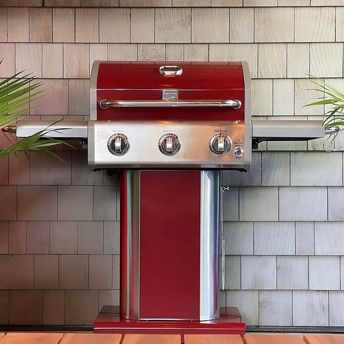A grill closed and placed on a deck.