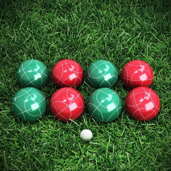 A set containing four green bocce balls, four red ones, and a white pallino ball.