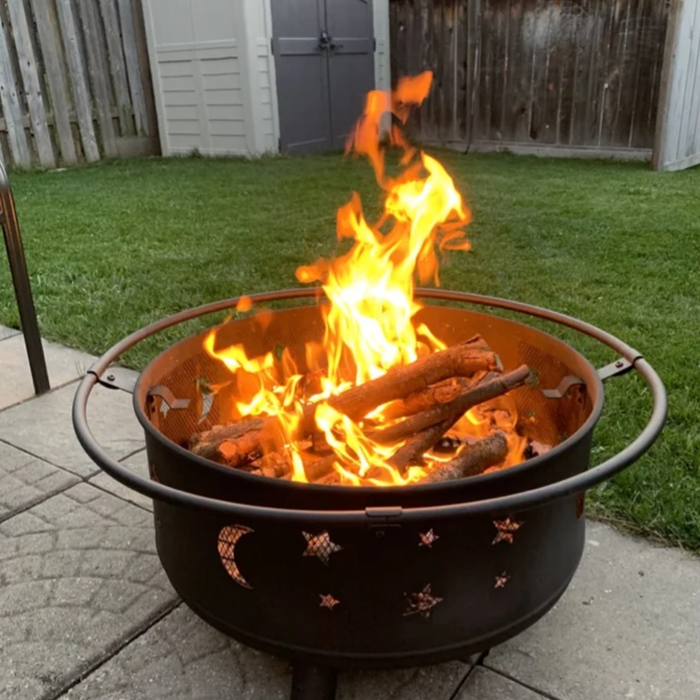 The fire pit with flames glowing in it