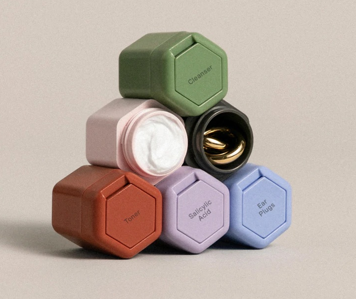 A pyramid-shaped stack of six vibrant, multicolored containers.