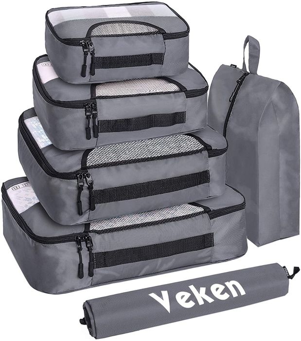 A set of gray packing cubes to help keep your suitcase organized and your belongings neatly packed.