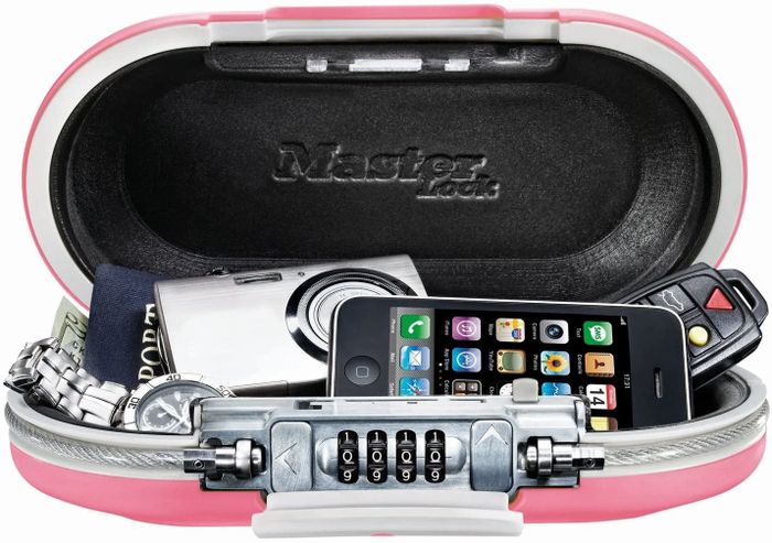 A pink MasterLock personal safe filled with belongings, offering a secure way to store valuables.
