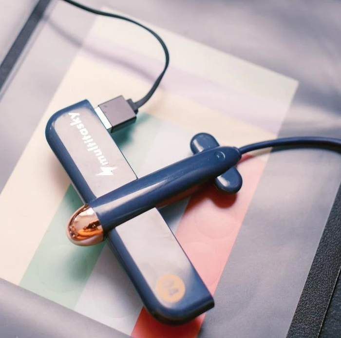 A desk featuring a blue airplane-shaped USB hub