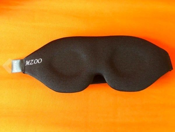 The front of a sleep mask designed to block out light for a peaceful rest.