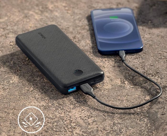 A black portable charger in action, charging an iPhone to keep you powered up wherever you are.