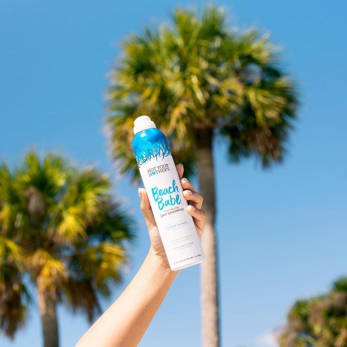 A person holding a can of sea salt spray
