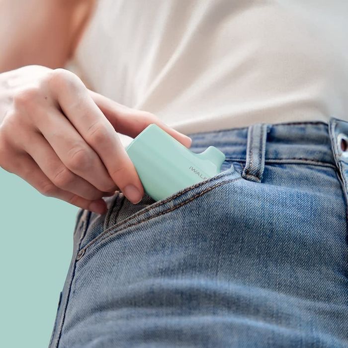 A model pulling the teal charger out of their pocket
