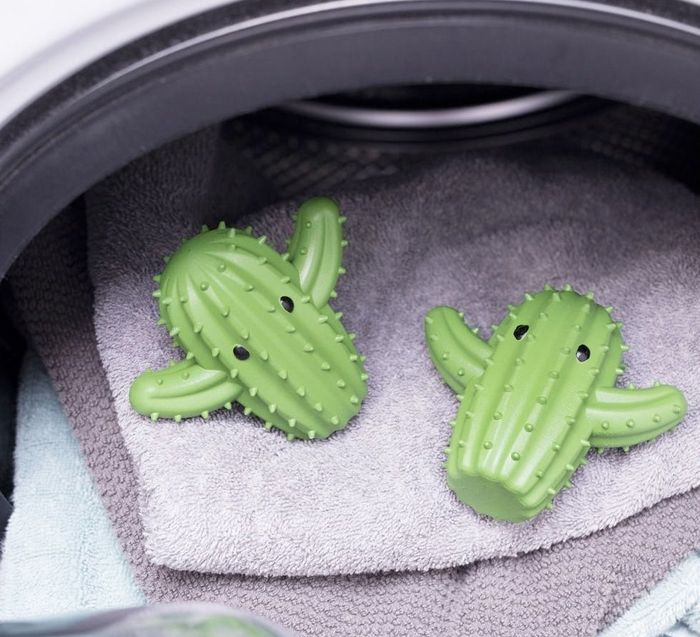 The cactus-shaped dryer balls resting atop a stack of freshly dried towels.