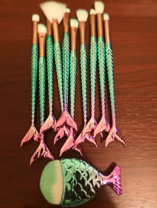 A collection of brushes—some large and fluffy, some smaller, and one with a fan-shaped design