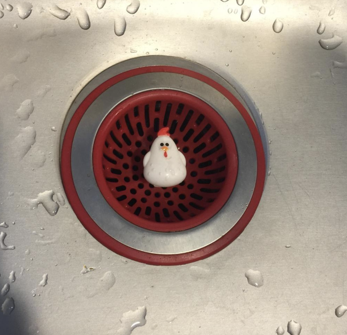 A reviewer shares a photo of the red sink strainer, showcasing its vibrant color and practical design.
