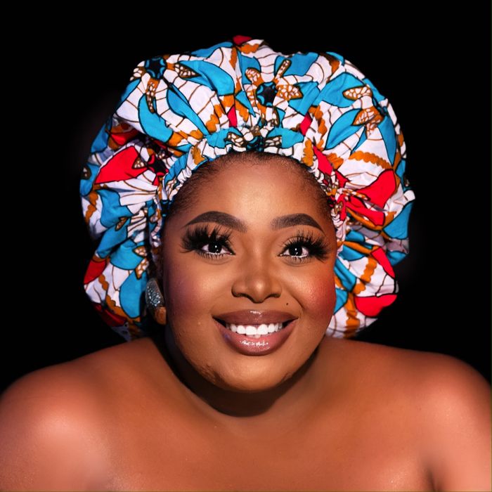 A Black model wearing the DEO silk bonnet.