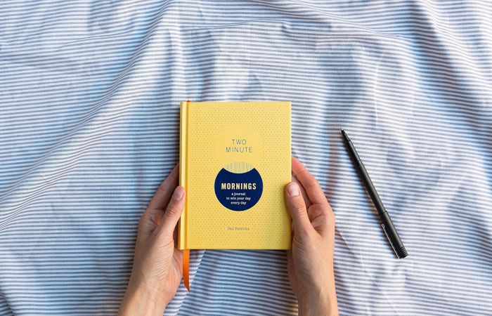 A visual of hands holding the journal.