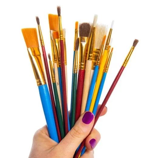 Hand holding a set of paintbrushes