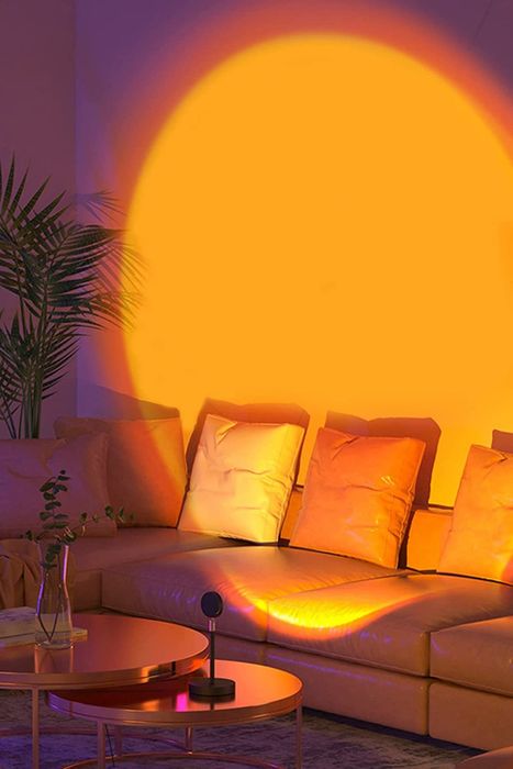 The sunset light is projected onto the living room wall, creating a calming ambiance