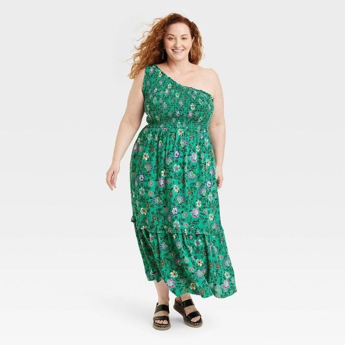 Model wearing a green floral print dress paired with black sandals