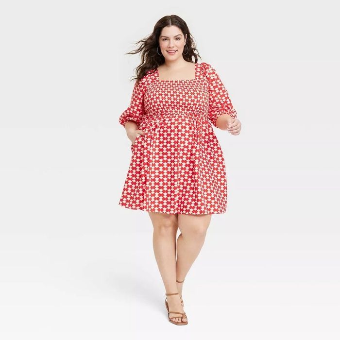 A model is pictured wearing a red and white checkered dress.