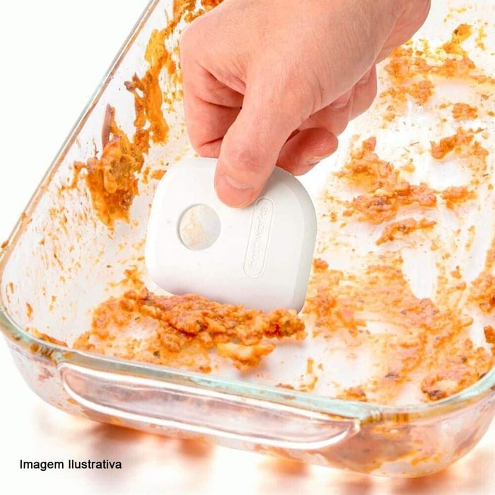 A model is shown using the scraper to clean a dirty pan, demonstrating its effectiveness.