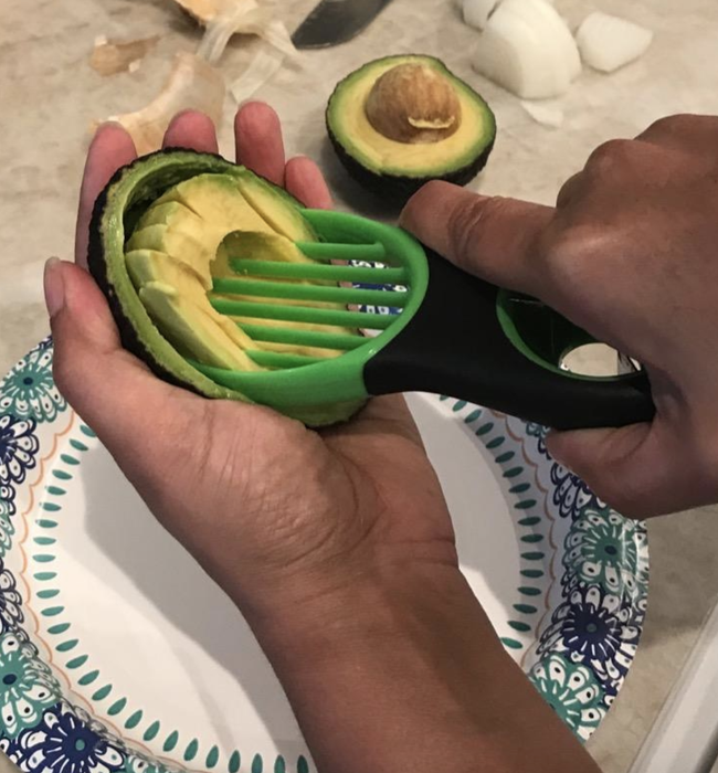 A reviewer demonstrating how to slice into an avocado with the tool.