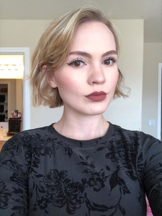 A reviewer showcasing perfectly applied winged liner