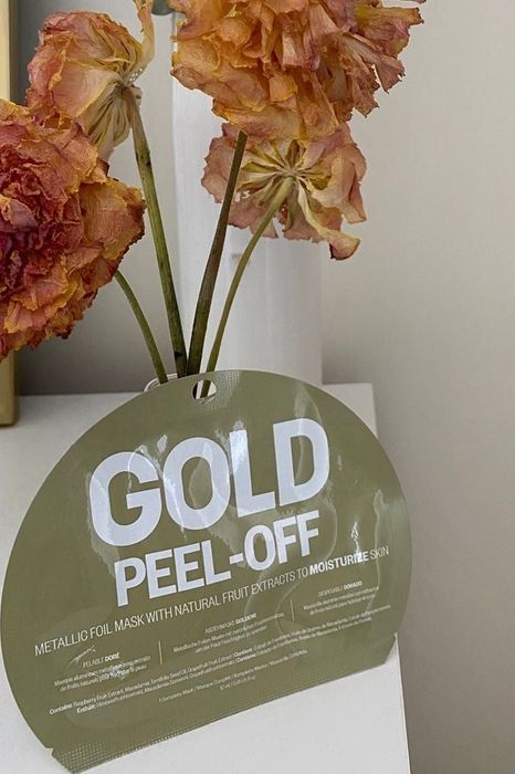 The gold mask shown in its elegant packaging, ready to deliver a spa-like experience.