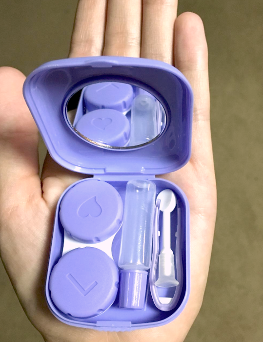 A reviewer's photo of a hand holding a sleek purple case.