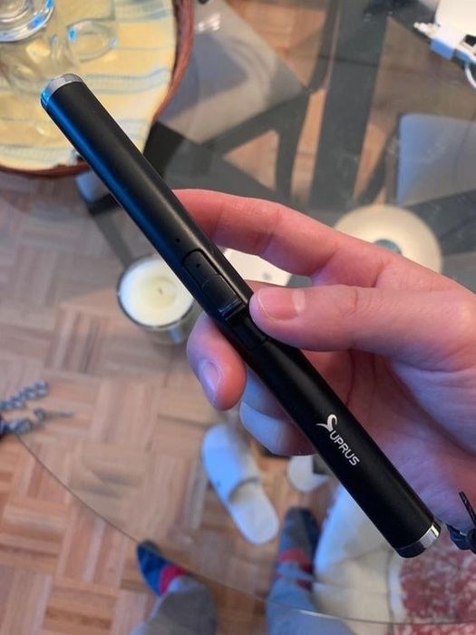 A reviewer demonstrates the full length of the rechargeable lighter by holding it in their hand.