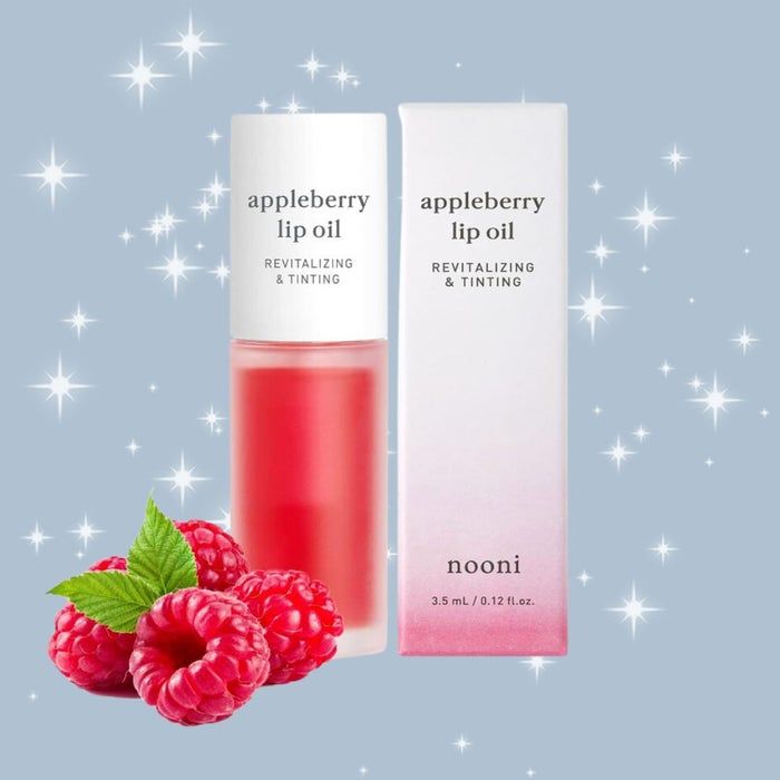 Nooni's Appleberry Lip Oil, infused with raspberries and shimmer, comes in a package labeled 'Revitalizing & Tinting, ml / 0.12 fl oz.'