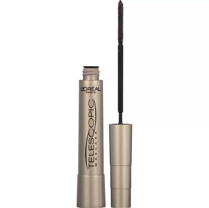 A close-up of the mascara tube with the lid removed to reveal the wand.