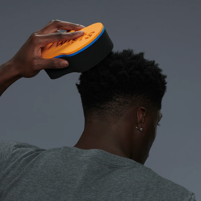A model using the twist sponge to style their hair.
