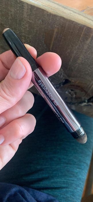 Reviewer holding the eyeshadow stick.