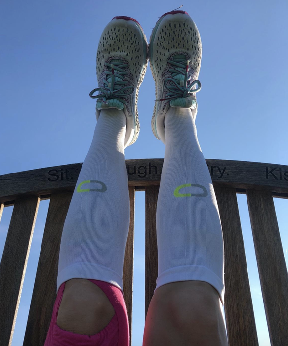 A reviewer wearing knee-high white compression socks.