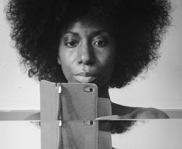 a person with a curly afro taking a selfie