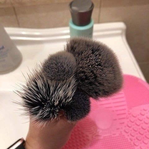 The same brushes are now displayed clean, demonstrating the effectiveness of the makeup cleaner.