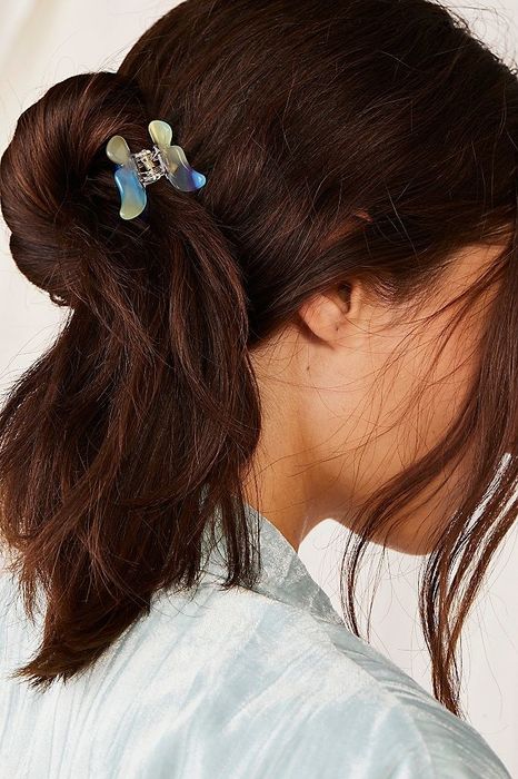 A model wearing the iridescent clip, highlighting its stylish and retro appeal.