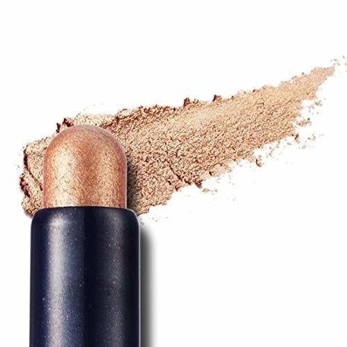the stick, showcasing its shiny gold hue and smooth, creamy texture