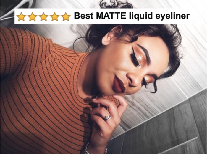 A reviewer shows off a winged black liquid eyeliner with a five-star caption reading