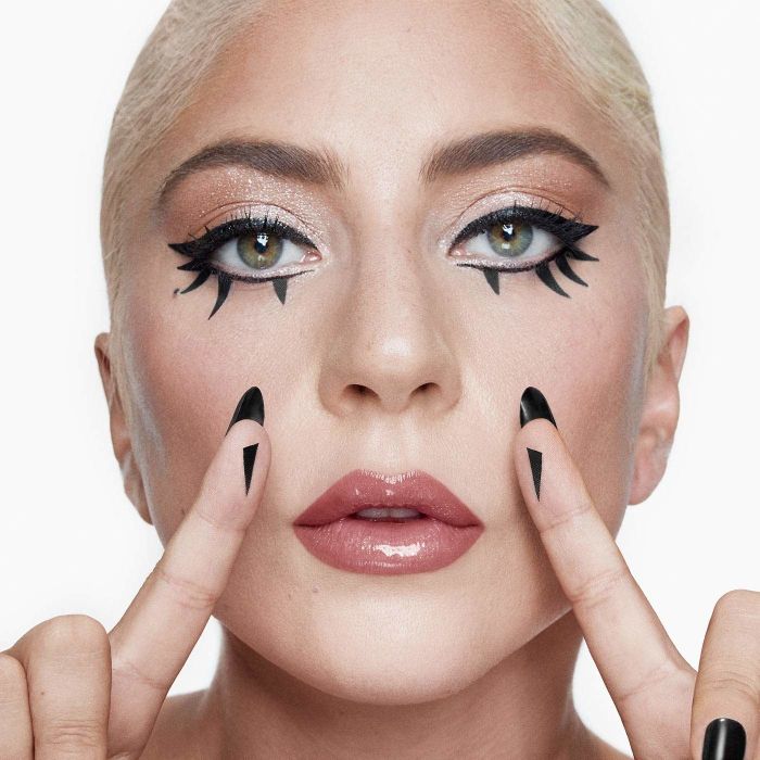 Lady Gaga modeling the eyeliner, complete with wing stickers