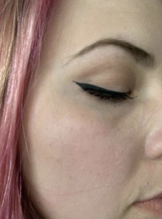 A close-up photo from a reviewer showing black liquid eyeliner on the eye