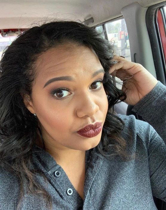 reviewer wearing a deep, dark burgundy shade