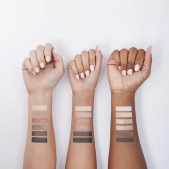 Arm swatches displaying the palette's colors on three distinct skin tones, highlighting its universal appeal.