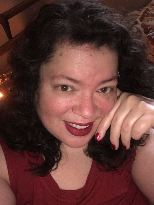 reviewer wearing a vibrant berry shade