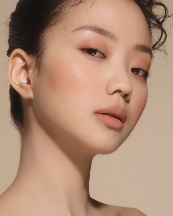 a lighter nude shade used across the model's face