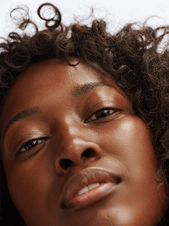 a detailed close-up of a model's glowing and flawless facial skin
