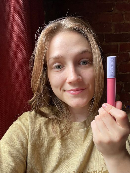 Mytour writer wearing the lip gloss and holding the tube up to their face