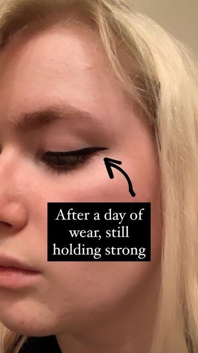 A reviewer’s photo wearing black liquid eyeliner with the caption: