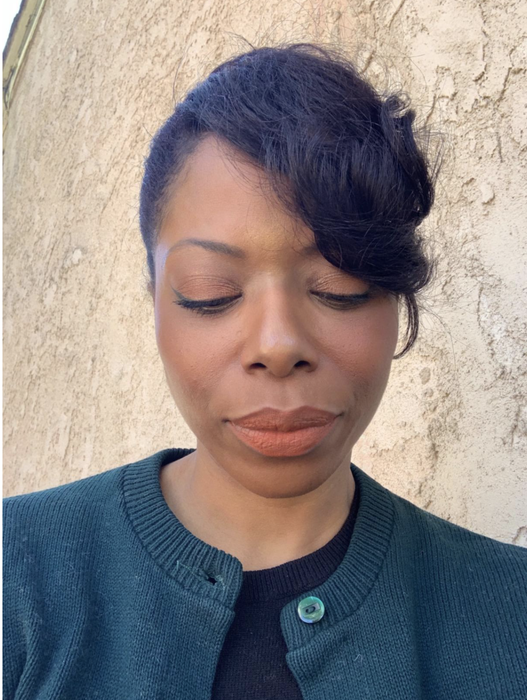 The reviewer is seen wearing a rich brown shade.